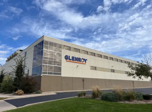 Exterior of Glenroy's flexible packaging manufacturing facility with company signage, glass windows, and landscaped grounds.